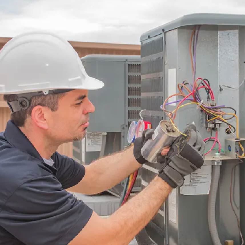 A HVAC technician doing maintenance work