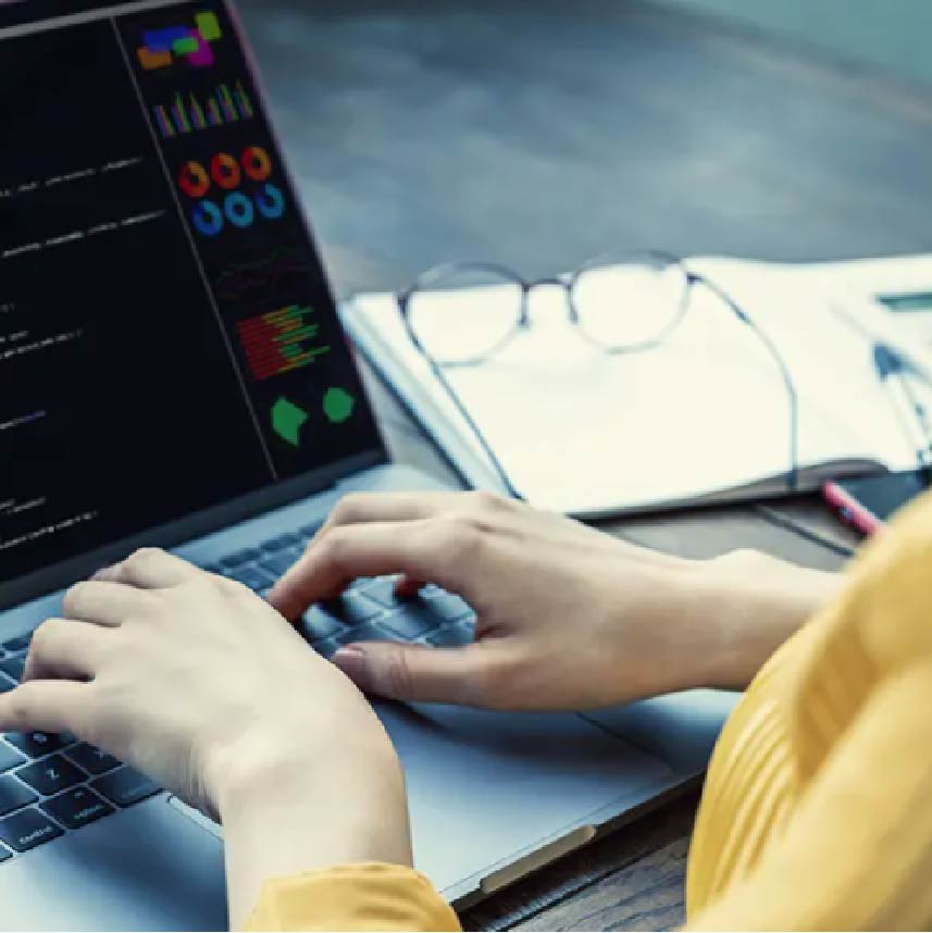 A lady typing at a computer keyboard