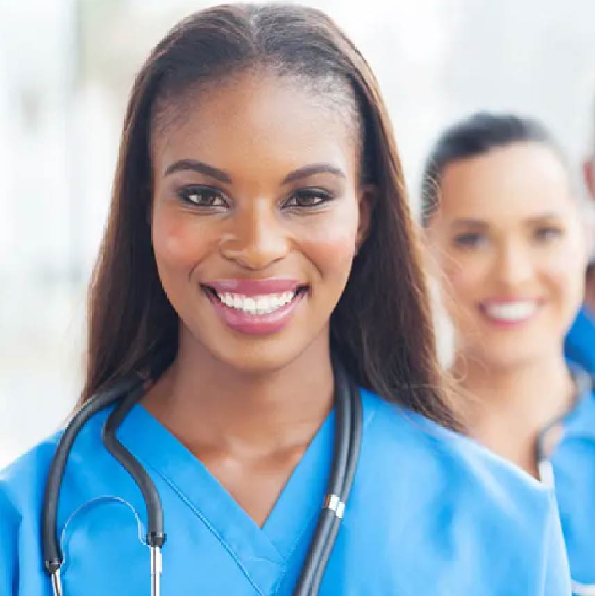 Two nurses smiling at you