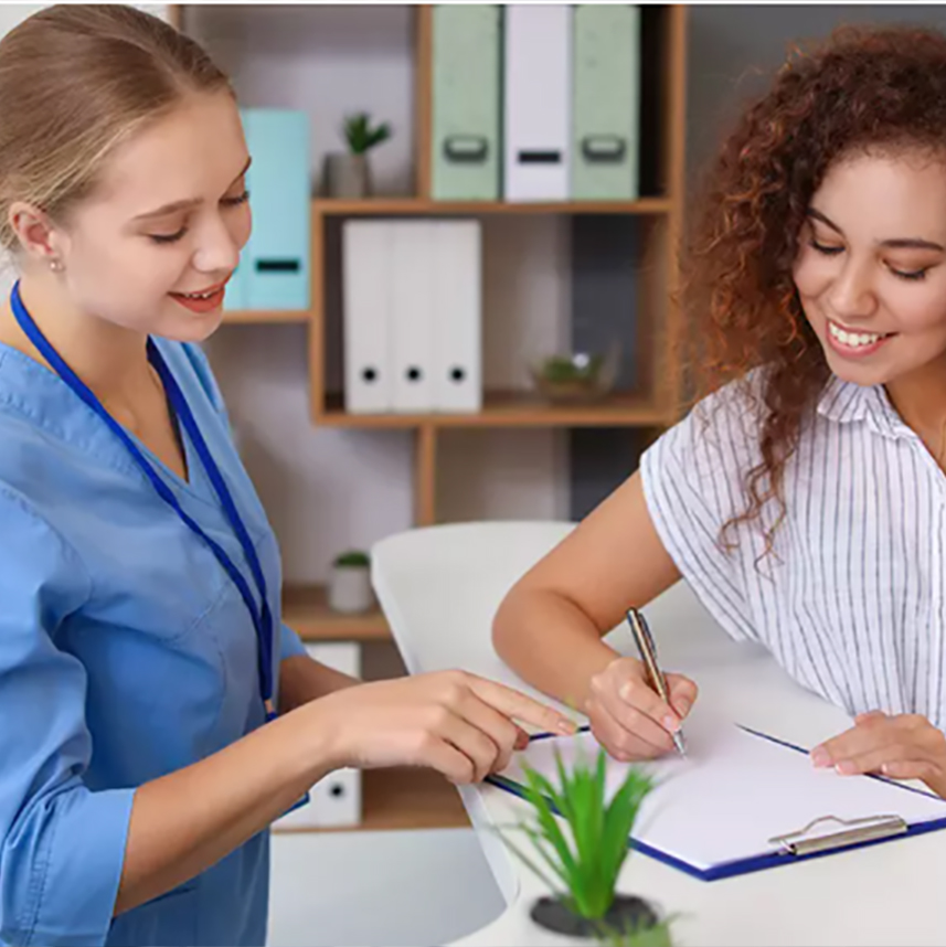 A nurse assisting a patient with filling out paperwork