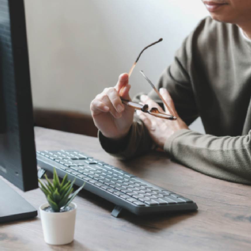 A man at a desk looking at a computer