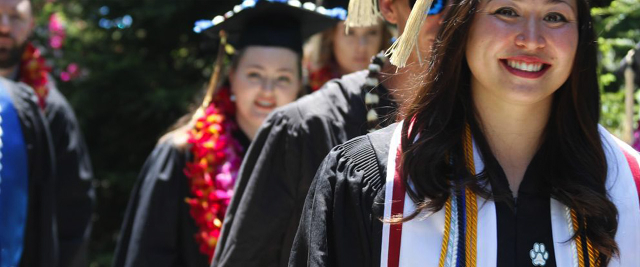 A line of graduate students after commencement