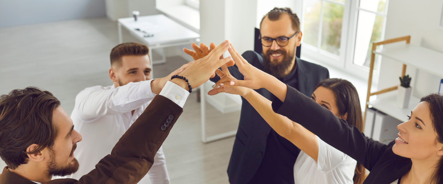 A team of professionals giving a group high five