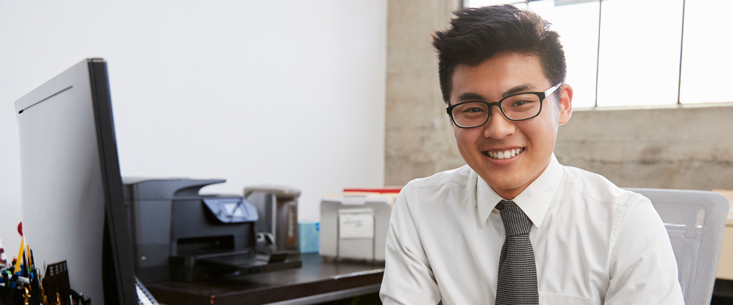 A young professional sitting by his computer