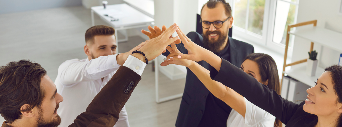 A team of professionals giving a group high five