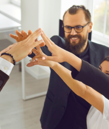 A team of professionals giving a group high five