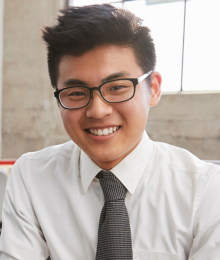 A young professional sitting by his computer